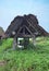 Japanese lake and boat roof of thatch.