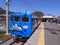 Japanese local blue train in the station of Kawaguchi lake with cute drawing of Thomas Land characters in the front head