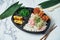 Japanese lunchbox - white rice, tempura shrimp fries, Japanese traditional omelette and chuka algae on a white background. Bento
