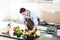 Japanese man preparing salad and cooking in kitchen