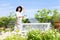 Japanese middle aged woman watering terrace