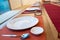 Japanese modern applied dining room style with eastern dish, fork, spoon, napkin and glass on the table