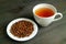 Japanese Mugicha or Barley Tea with a Plate of Roasted Barley on Wooden Table