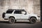 Japanese offroad used white car Toyota Hilux Surf, right side view