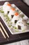 Japanese onigiri stuffed with salmon and sesame close-up. vertical