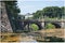 Japanese palace in Tokyo with reflection and bridge in foreground