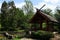 Japanese pavilion with pond and columns as pathway across the pond, far east trees and decorative shrubs around, spring season