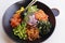 japanese poke bowl with edamame, salmon, wakame seaweed, mango, radish, cucumber, onion and rice served with sweet soy sauce,