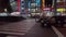 Japanese police tiny kei class car waiting at traffic light in Shinjuku at night.