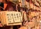 Japanese prayers written on pieces of wood hang in a temple