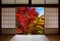 Japanese rice paper wood doors opened to an autumn forest with red and yellow fall colors