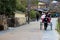 Japanese rickshaw driver carrying a couple