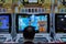 Japanese salary man playing arcade Dragonball in Tokyo, Japan shopping mall. Middle aged old man playing video games wearing suit