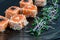 Japanese salmon Tataki with sesame and sprouts of fresh herbs. On a black clay plate. Macro photo,