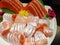 Japanese sashimi salmon buffet in white disk with ice.