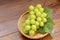 Japanese Shine Muscat Grape in basket  on wooden Background, Sweet Green grape on wooden background.