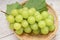 Japanese Shine Muscat Grape in basket  on wooden Background, Sweet Green grape on wooden background.