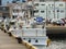 A Japanese shipping vessel docked at pier with building in background