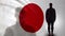 Japanese soldier silhouette standing against national flag, proud army sergeant