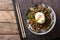 Japanese spicy beef Soboro with egg benedict, rice and green onion close-up. horizontal top view
