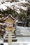 Japanese stone and wooden lantern with snow at Hida-sannogu Hie-Jinja shrine in winter season . At Gifu , Hida Takayama , Japan