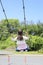 Japanese student girl on the swing appearance from behind