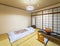 Japanese-style bedroom with tatami mats, shoji doors, fusuma walls and a futon mattress.