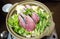 Japanese style hot pot with raw fish and vegetabels in ceramic pot