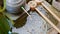 Japanese style traditional bamboo fountain and stone basin for hand washing