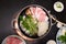 Japanese sukiyaki hot pot with vegetable, beef slice, raw egg cooking in hot pot