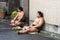 Japanese Sumo Wrestlers are Resting on a Street