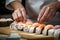 A Japanese sushi chef\\\'s artistry: crafting fresh salmon rolls