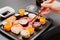 Japanese sushi food. Maki ands rolls with tuna, salmon, shrimp, crab and avocado on black dish