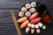 Japanese sushi food. Maki ands rolls with tuna, salmon, shrimp, crab and avocado with two sauces close-up on a slate. horizontal