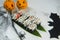 Japanese Sushi Roll near Halloween decoration. Spider, bat, black spider web and little pumpkins with scary painted faces