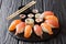 Japanese sushi on a rustic dark background. Sushi rolls, nigiri, maki, soy sauce. Sushi set on a table. Asian food. Horizontal