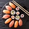Japanese sushi on a rustic dark background. Sushi rolls, nigiri, maki, soy sauce. Sushi set on a table. Asian food. top view from