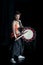 Japanese Taiko drummer hits the drum on stage