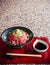 Japanese Tataki raw beef cuisine with ginger, onion, spring onion and soy sauce set on red wooden tray