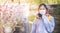 Japanese teenager smelling Blossom flower