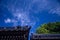 Japanese temple roof architecture agains a blue sky