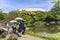 Japanese tourists holding sun umbrellas walking in the Koishikawa Korakuen Park.