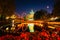 The Japanese Tower and rides at night, reflecting in a lake at T