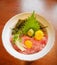 Japanese traditional cuisine minced raw tuna belly on rice bowl maguro don with egg yolk, bean sprouts, wasabi