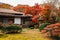 Japanese traditional house with autumn maple trees at Koishikawa Korakuen Garden in Tokyo, Japan