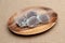 Japanese traditional sweet called Daifuku Mochi on wooden platter isolated on jute background. Close-up. Top view