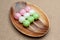 Japanese traditional sweet called Dango Mochi on wooden platter. Isolated on jute background