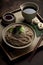 Japanese udon noodles with soy sauce and chopsticks on dark background