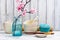 Japanese utensils, dinnerware, chopsticks and branch of blooming sakura on white asian background