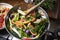 Japanese woman cooking stir fried vegetables